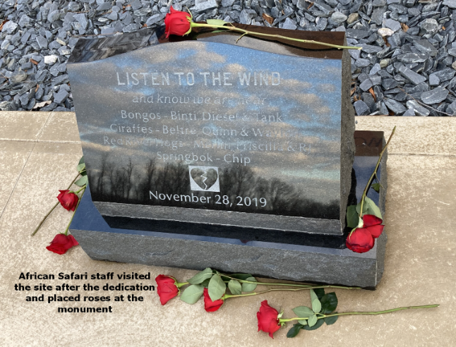 Memorial plaque with roses and engraved text.