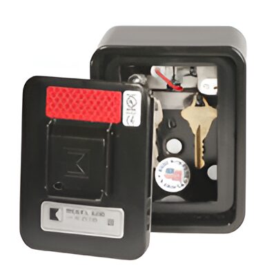 Wall-mounted key safe with open door.