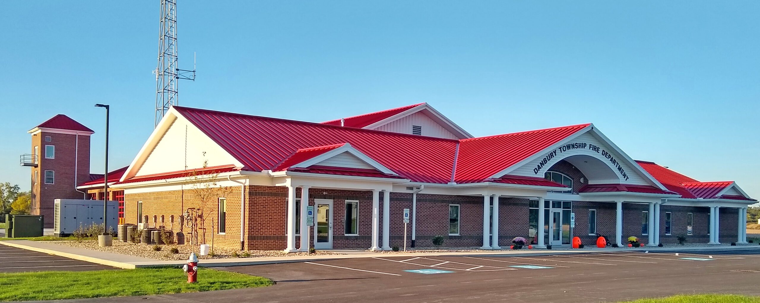Red-roofed building with clear blue sky.