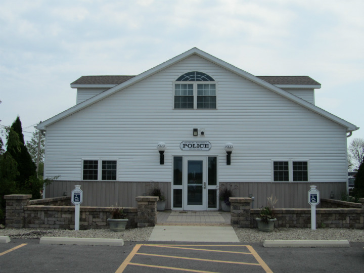 Police station building with parking spaces.