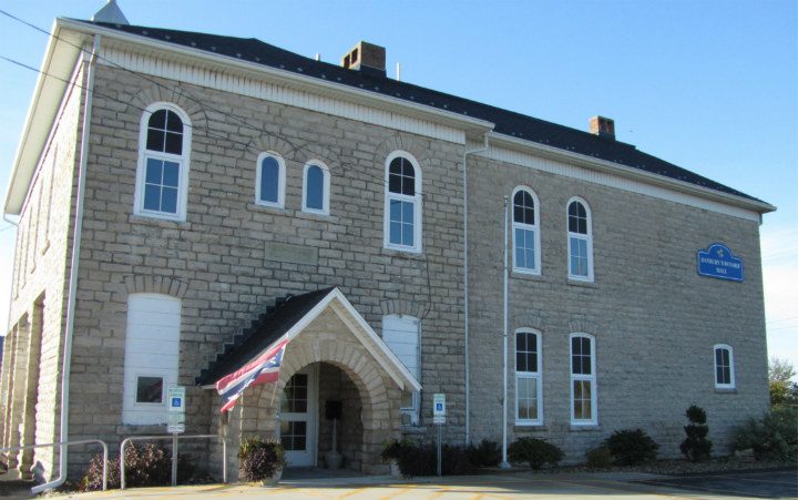 Old stone building with arched entrance.