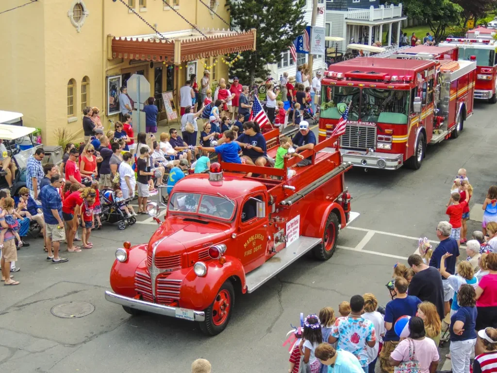 Red Fire Truck in a parade with people along the roadway