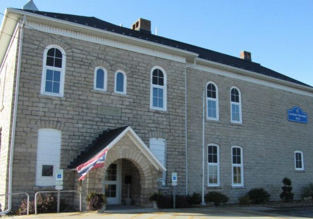 Old stone building with arched entrance.